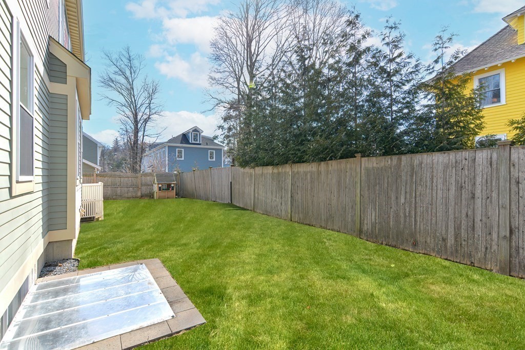 89 Walker Street, Unit 89 Newton, MA 02460 - Photo 39 of 42 a view of a backyard with a garden