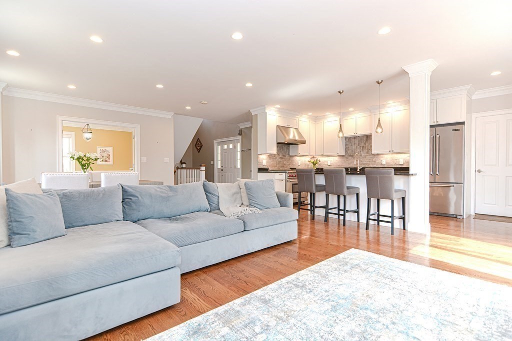 89 Walker Street, Unit 89 Newton, MA 02460 - Photo 6 of 42 a living room with furniture and a dining table with wooden floor