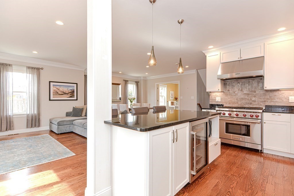 89 Walker Street, Unit 89 Newton, MA 02460 - Photo 8 of 42 a large kitchen with stainless steel appliances kitchen island granite countertop a sink and cabinets