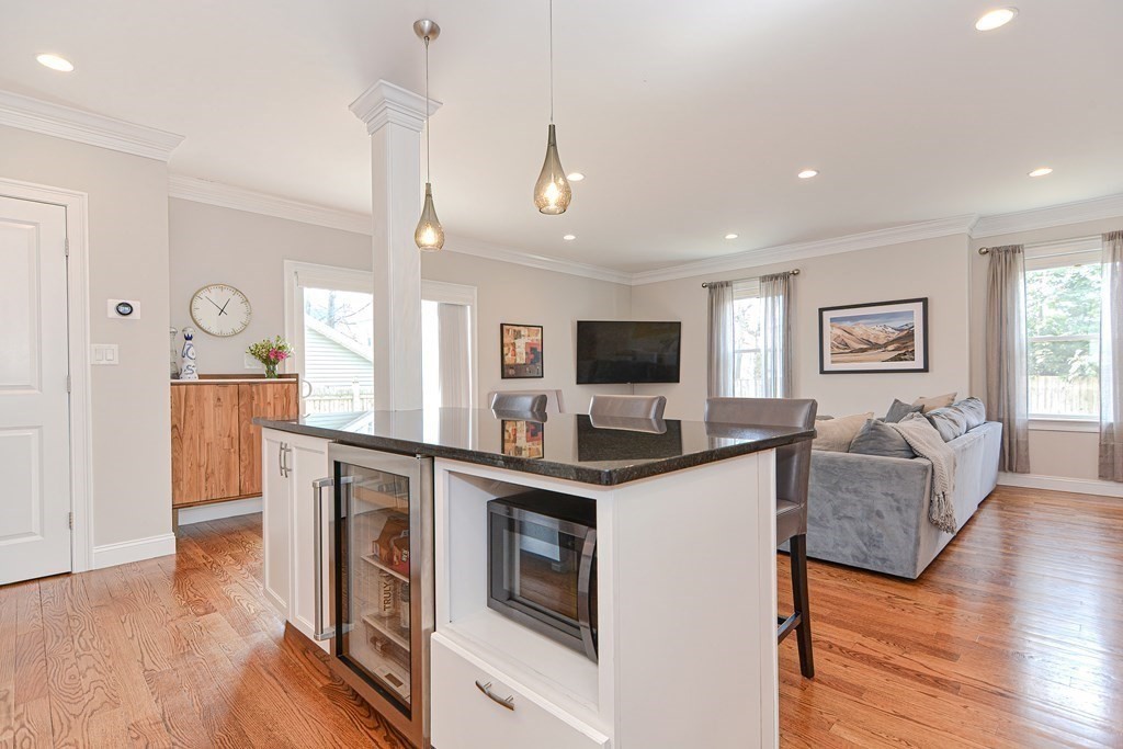 89 Walker Street, Unit 89 Newton, MA 02460 - Photo 9 of 42 a kitchen with stainless steel appliances granite countertop a stove top oven a sink dishwasher and a refrigerator with wooden floor