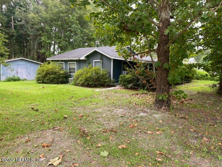 85152 Myrtice Road Yulee, FL 32097 - Photo 1 of 7 a front view of a house with yard and green space