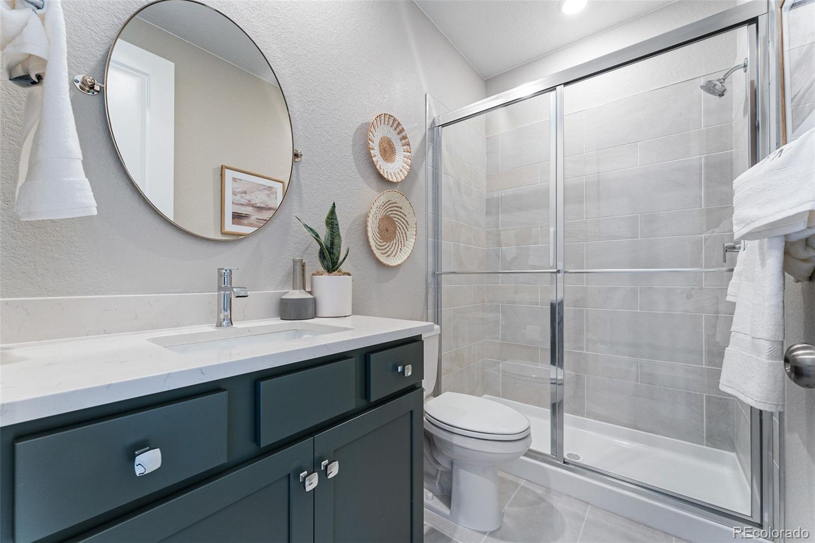 4261 Ridgewalk Point Castle Rock, CO 80108 - Photo 12 of 39 a bathroom with a sink a toilet and a mirror