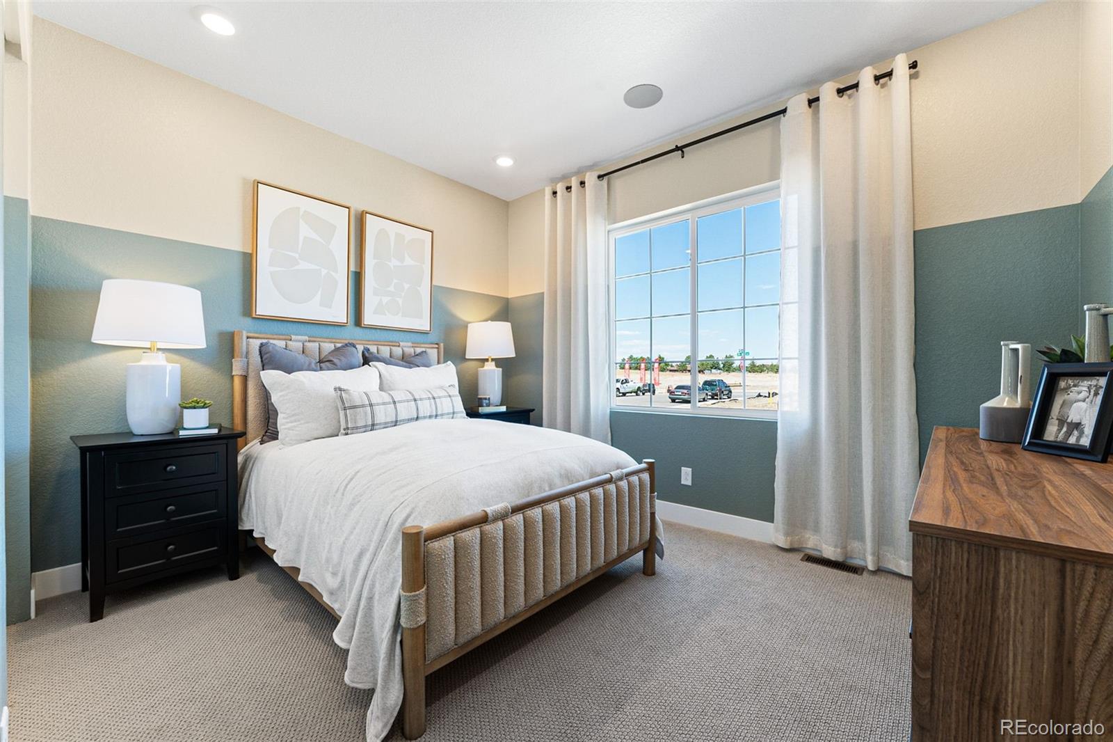 4261 Ridgewalk Point Castle Rock, CO 80108 - Photo 13 of 39 a bedroom with a bed and a lamp on dresser