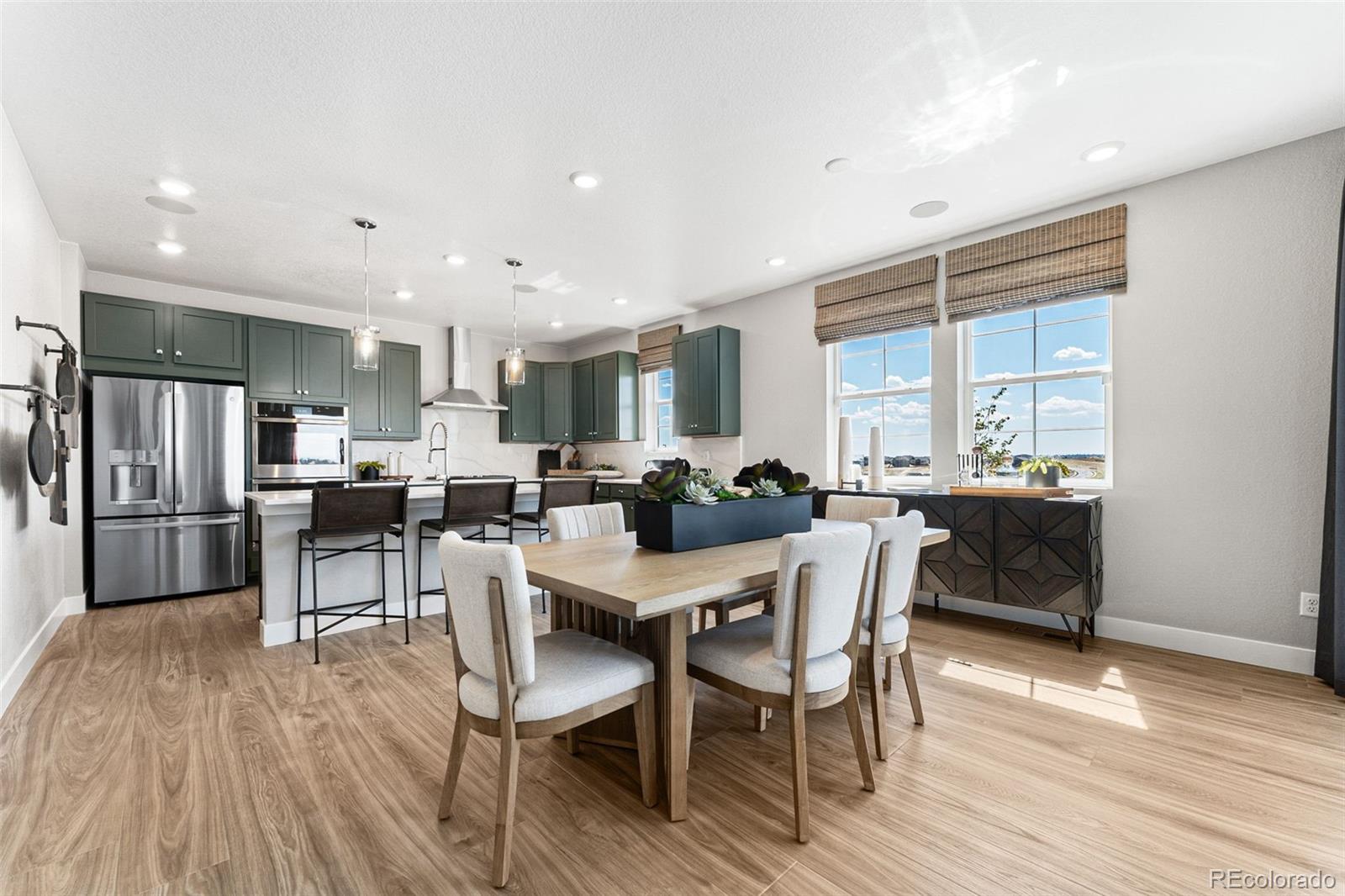 4261 Ridgewalk Point Castle Rock, CO 80108 - Photo 22 of 39 a view of a dining room with furniture a rug and wooden floor