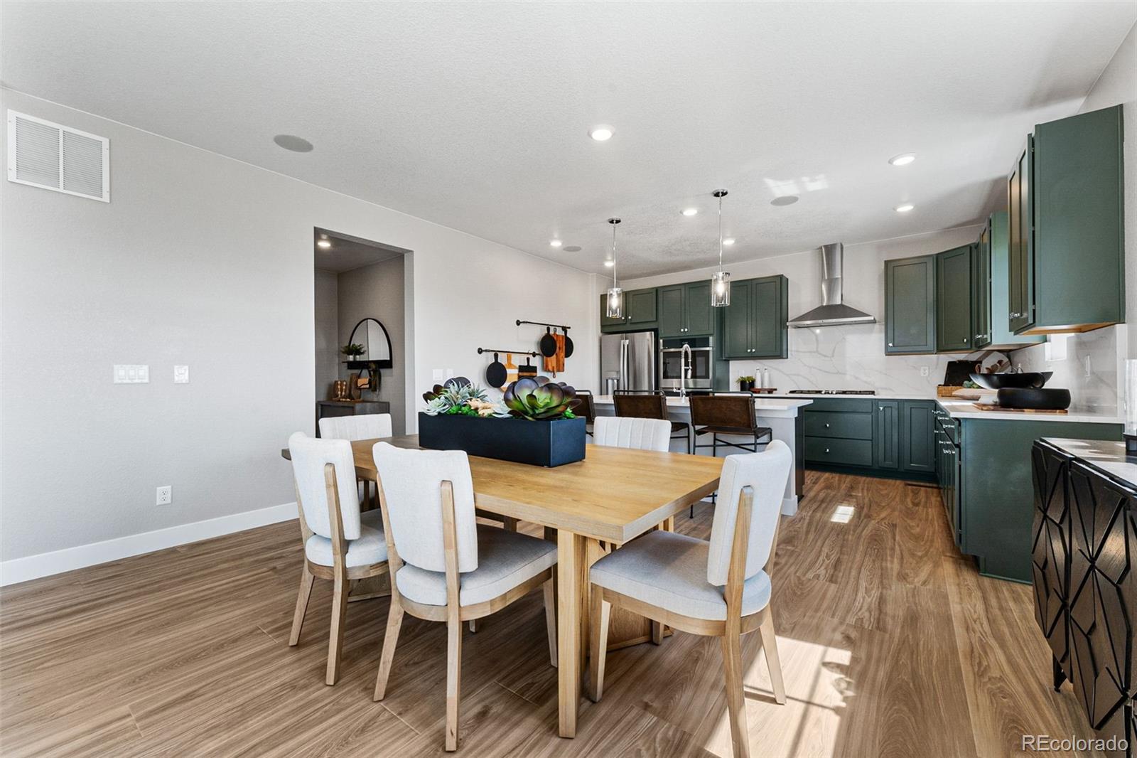 4261 Ridgewalk Point Castle Rock, CO 80108 - Photo 23 of 39 a view of a dining room with furniture and wooden floor