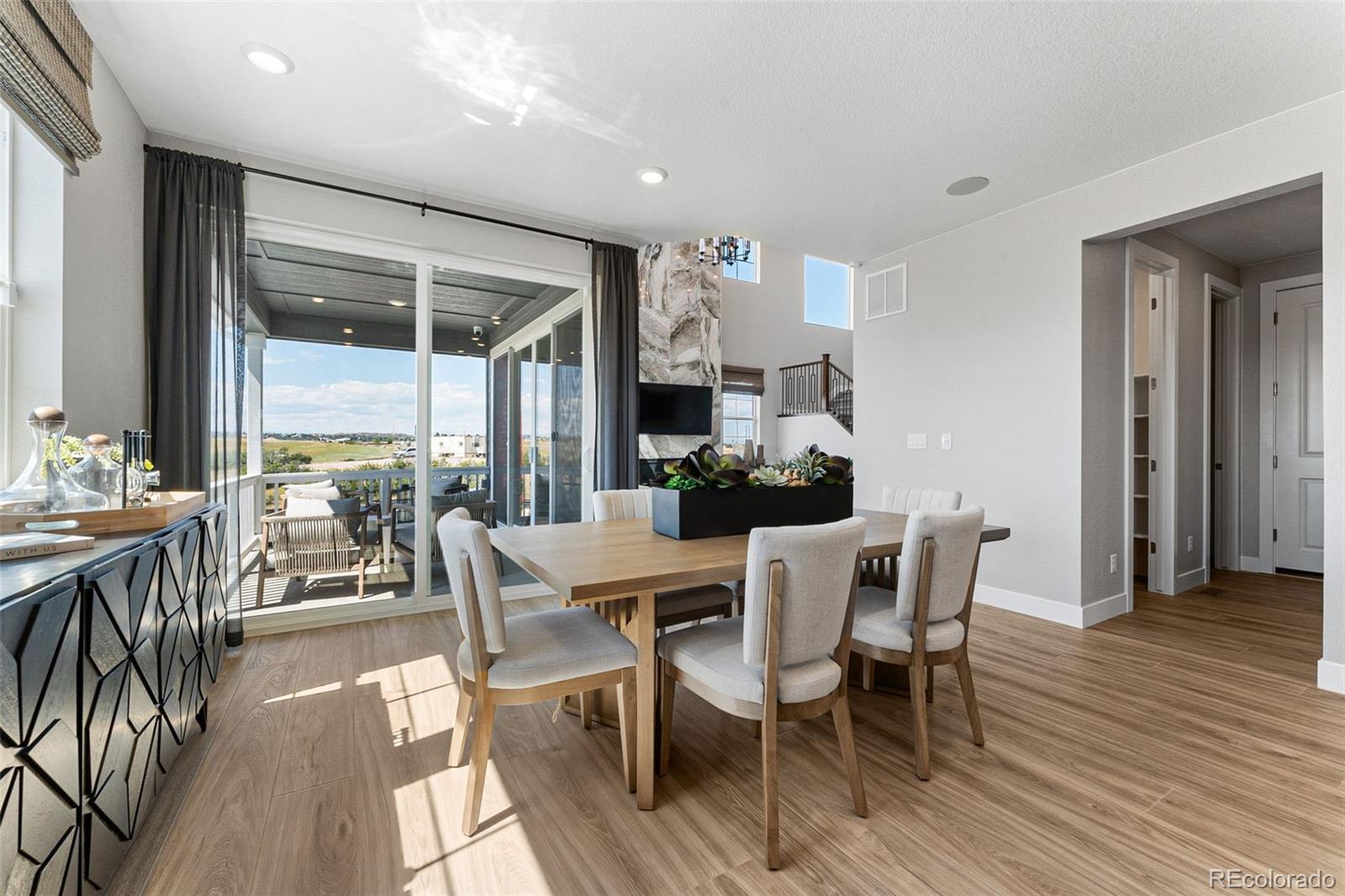 4261 Ridgewalk Point Castle Rock, CO 80108 - Photo 24 of 39 a view of a dining room with furniture and wooden floor