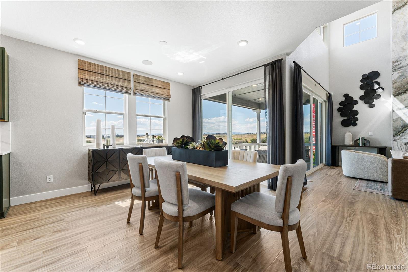 4261 Ridgewalk Point Castle Rock, CO 80108 - Photo 25 of 39 a view of a dining room with furniture and wooden floor