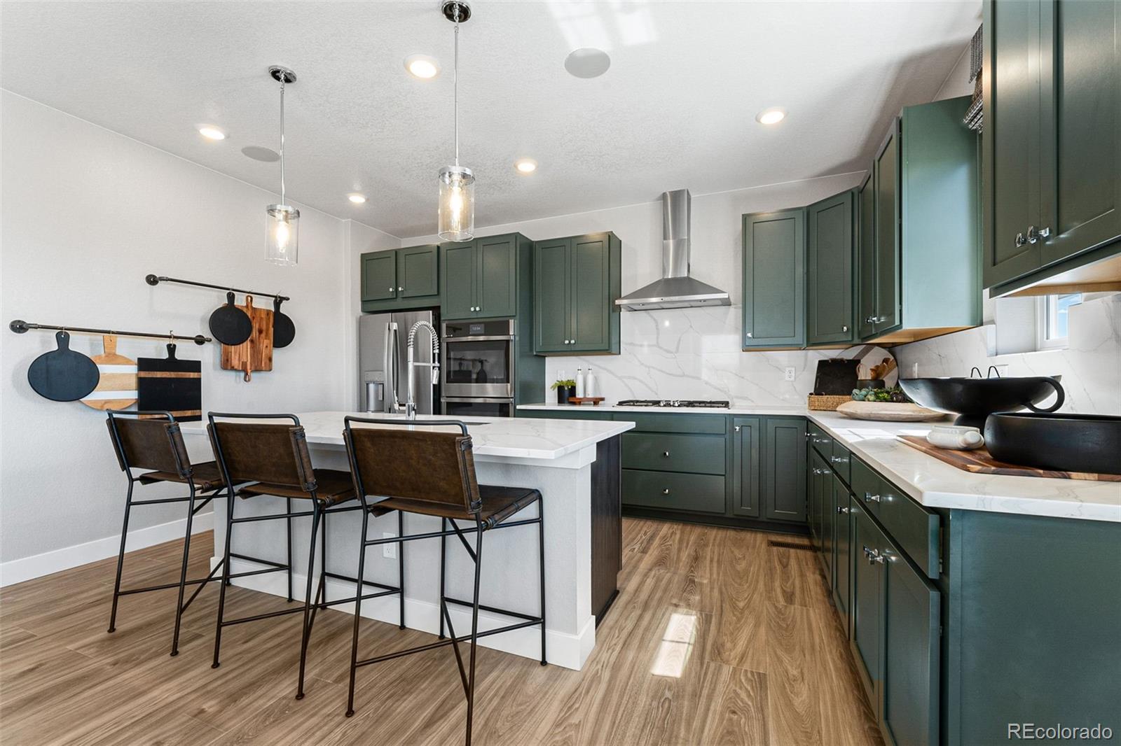 4261 Ridgewalk Point Castle Rock, CO 80108 - Photo 27 of 39 a kitchen with a sink cabinets and wooden floor