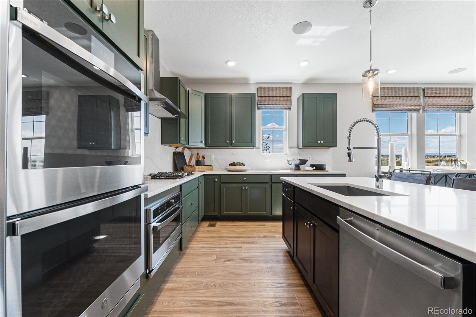 4261 Ridgewalk Point Castle Rock, CO 80108 - Photo 31 of 39 a kitchen with stainless steel appliances granite countertop sink a stove and cabinets