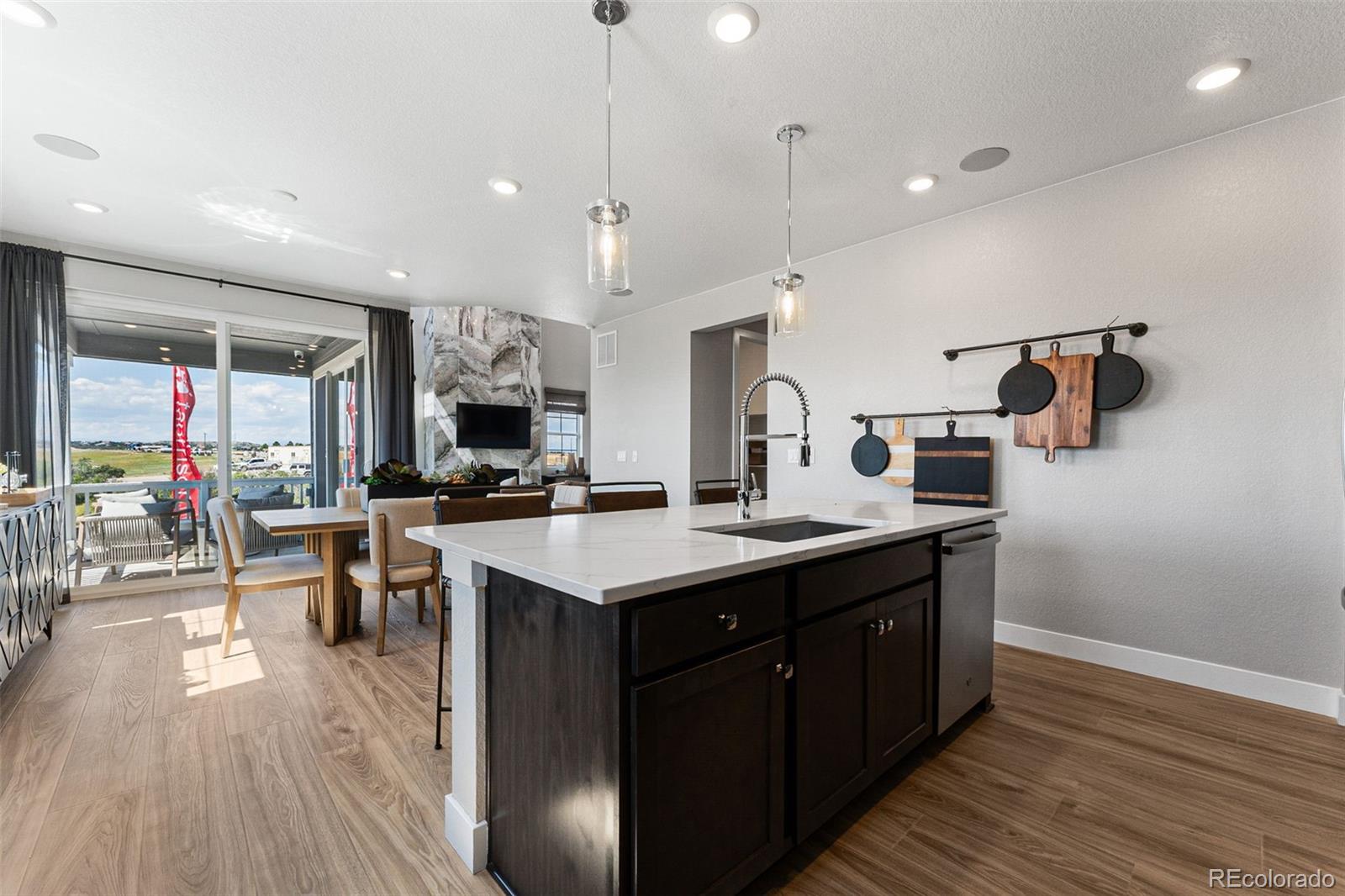 4261 Ridgewalk Point Castle Rock, CO 80108 - Photo 33 of 39 a kitchen with a sink a counter space appliances and wooden floor