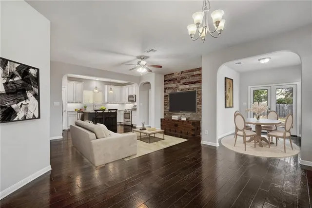 a view of a livingroom with a furniture wooden floor and a large window