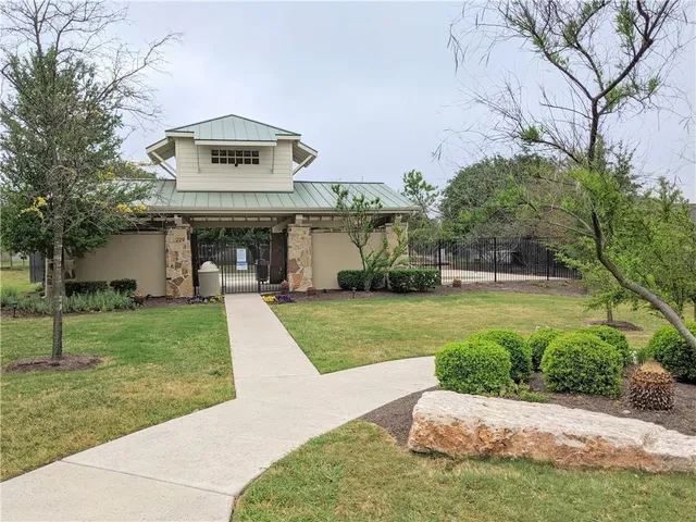 a view of a house with a yard and garage
