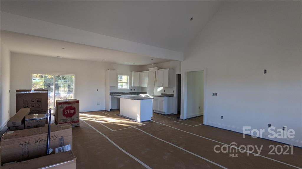 2105 State Rd S-46-1474, Unit 1 Clover, SC 29710 - Photo 6 of 31 a living room with furniture a flat screen tv and kitchen view