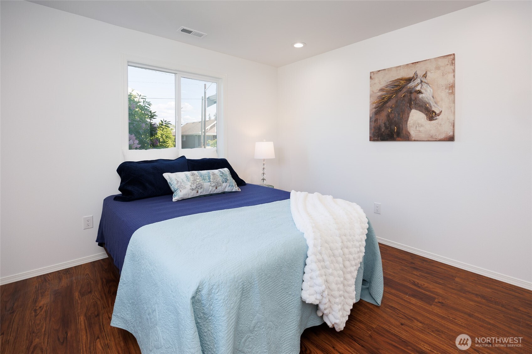 1708 Walnut Street Everett, WA 98201 - Photo 16 of 32 a bedroom with a bed and wooden floor