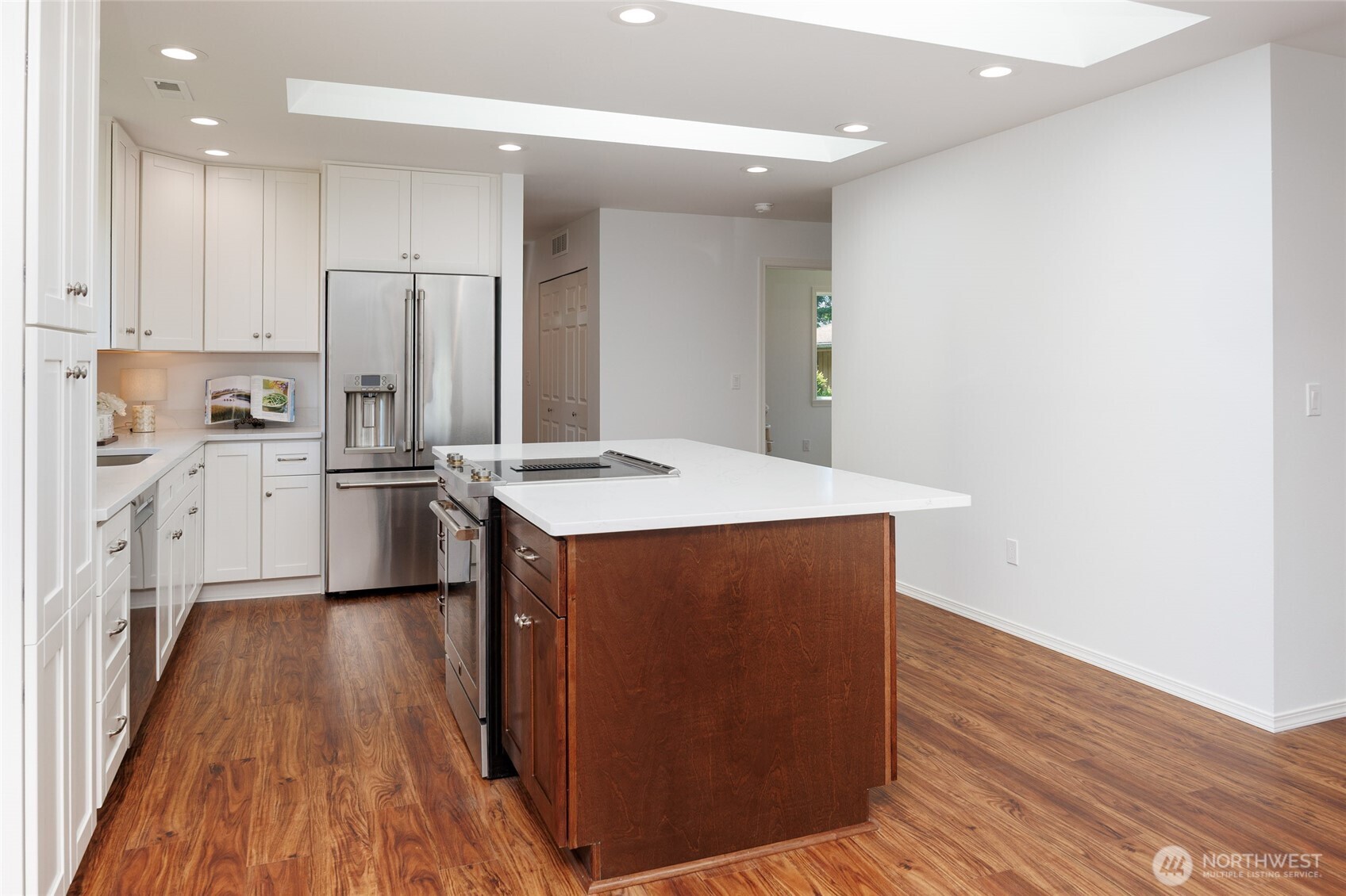 1708 Walnut Street Everett, WA 98201 - Photo 27 of 32 a kitchen with stainless steel appliances a refrigerator and a wooden floor