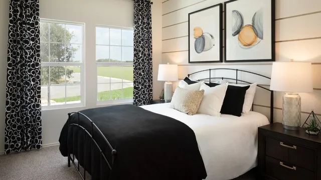 a bedroom with a bed and dresser with mirror