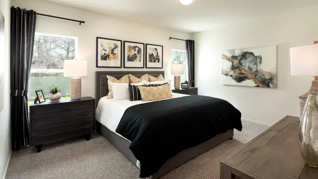 a bedroom with a bed and a painting on the wall