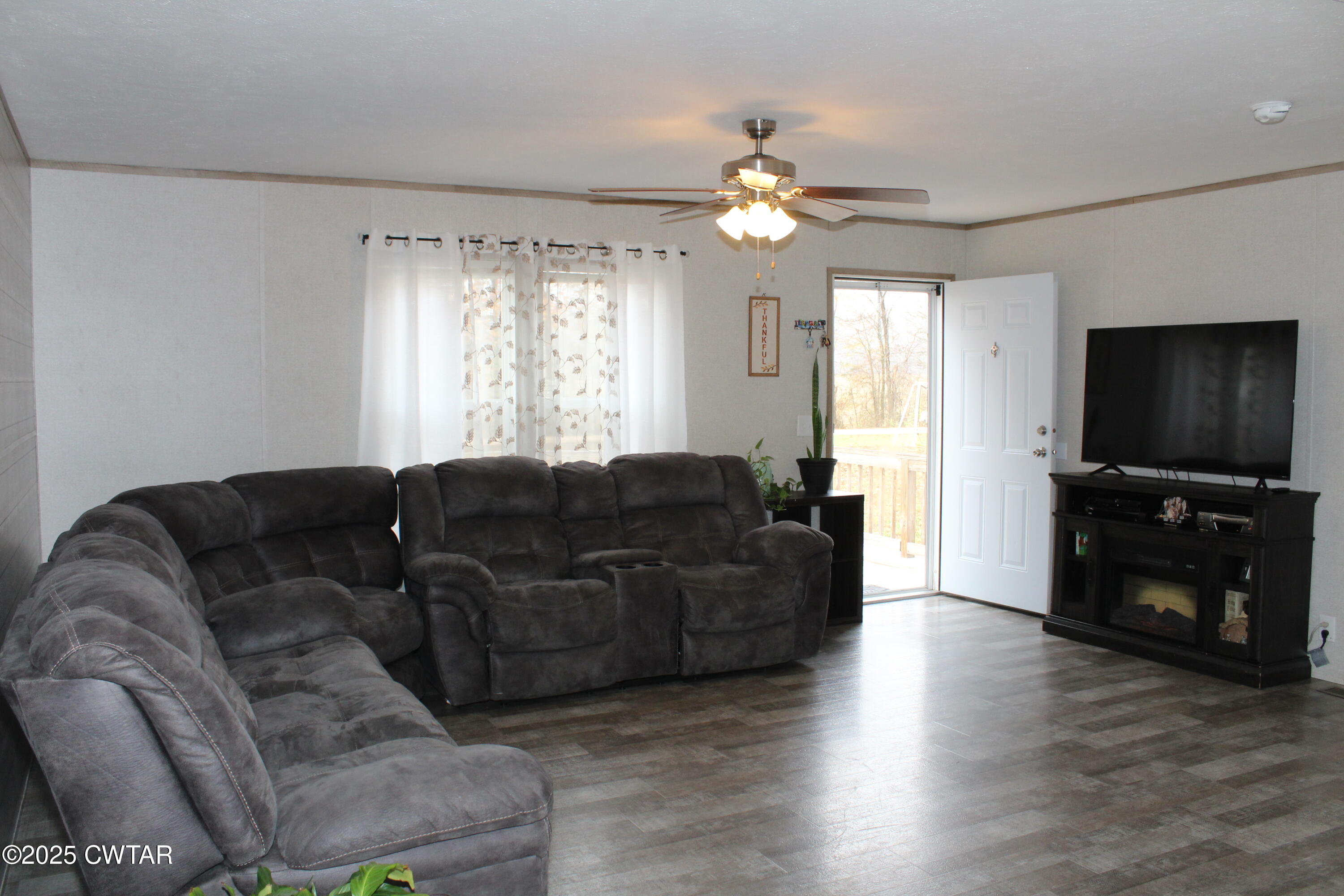 34 Rubin White Road Bradford, TN 38316 - Photo 14 of 35 a living room with furniture a flat screen tv and a window