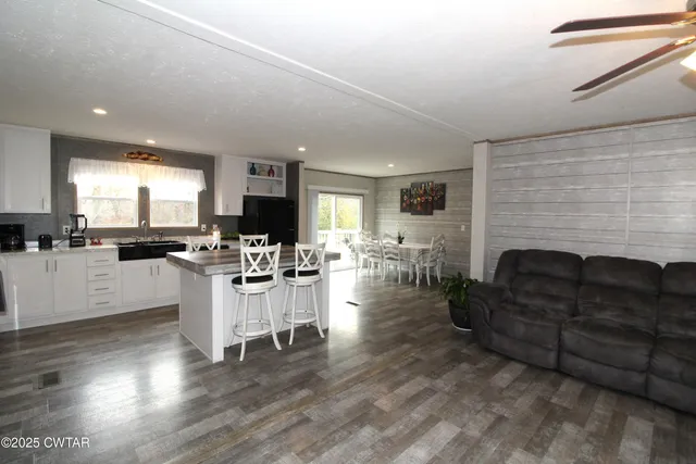 a living room with furniture fireplace and flat screen tv