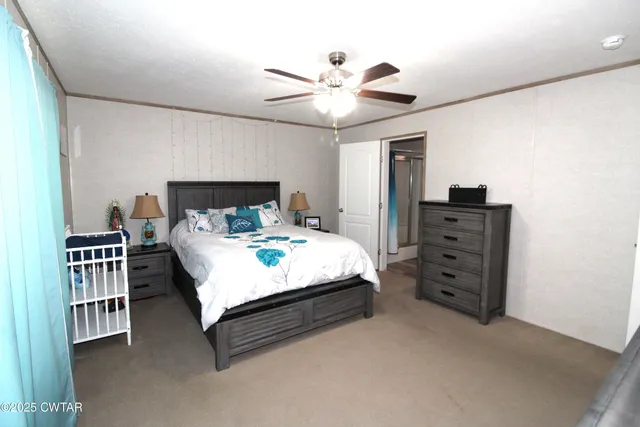 a bedroom with a bed dresser and a window