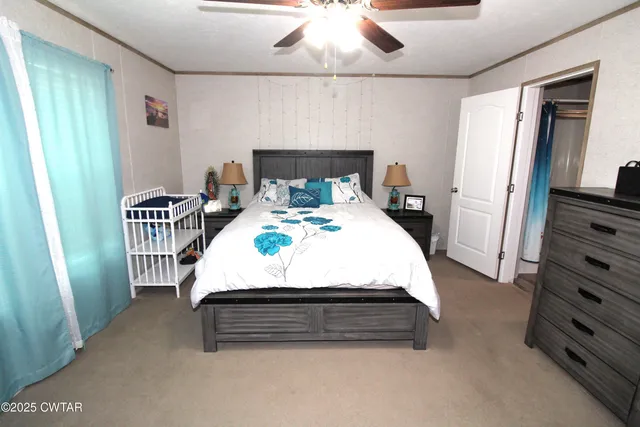 a bed sitting in a bedroom next to a window