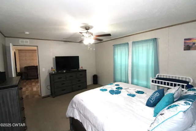 a bedroom with a bed and a flat screen tv