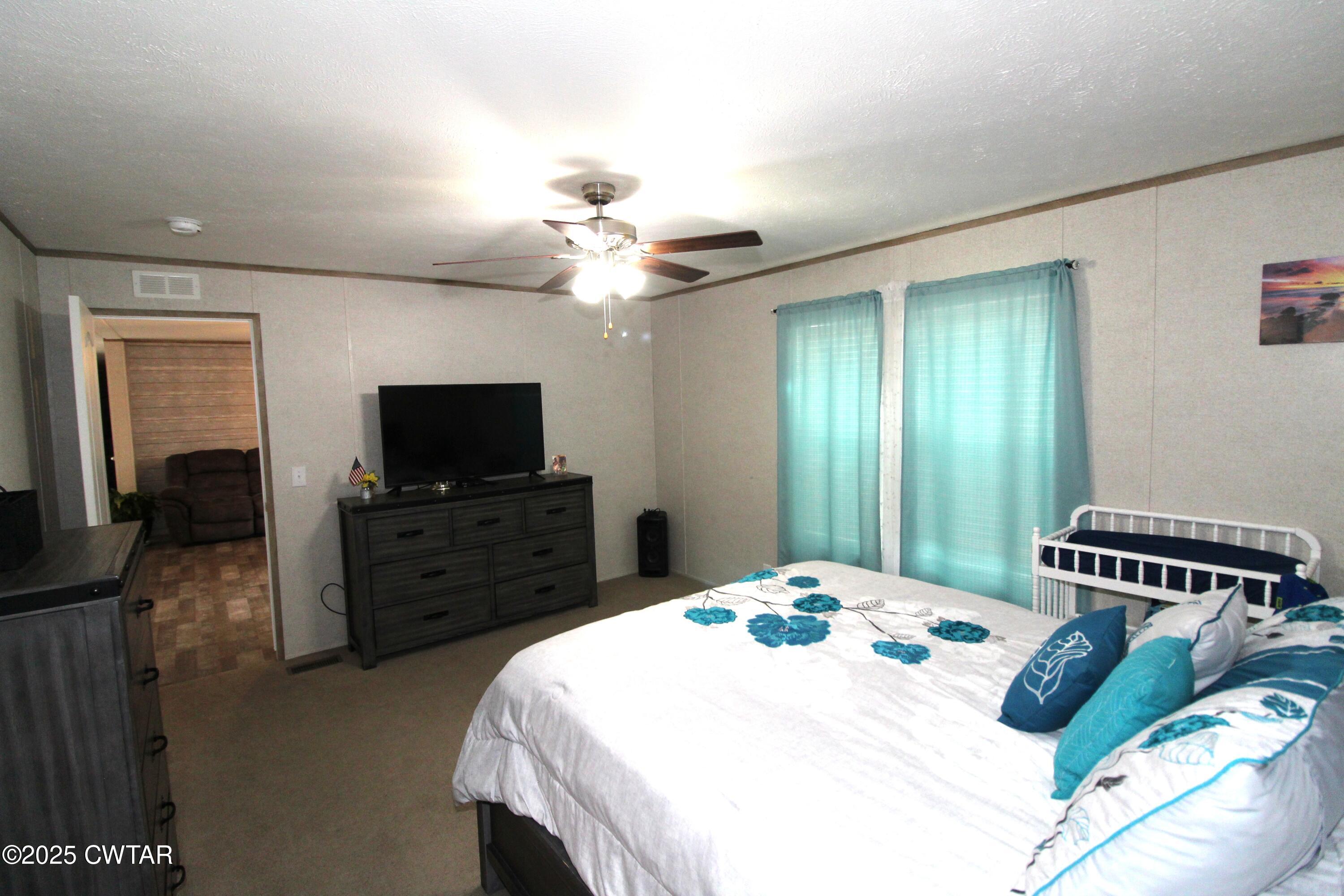 34 Rubin White Road Bradford, TN 38316 - Photo 24 of 35 a bedroom with a bed and a flat screen tv