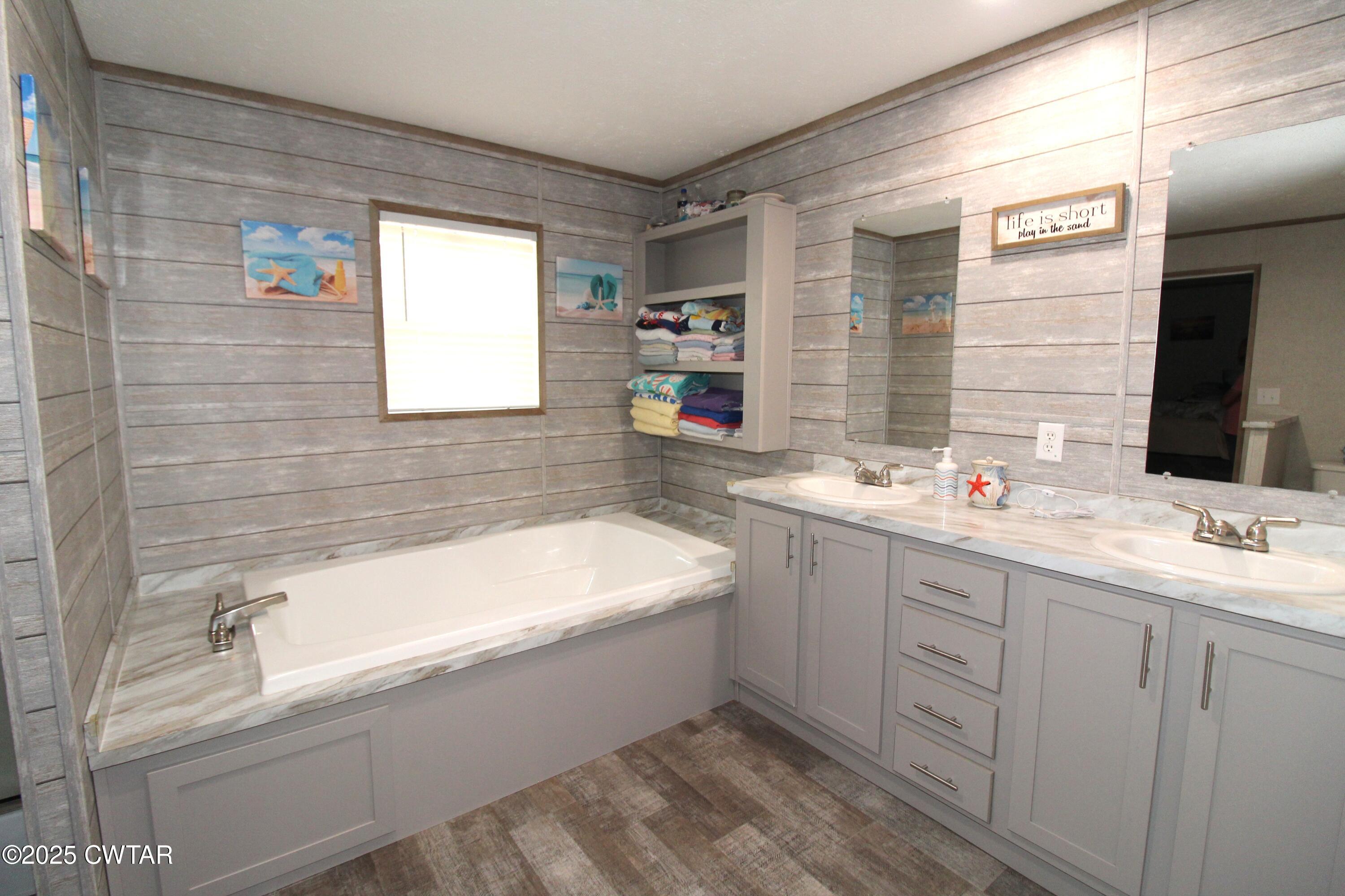 34 Rubin White Road Bradford, TN 38316 - Photo 25 of 35 a bathroom with a bathtub sink and mirror