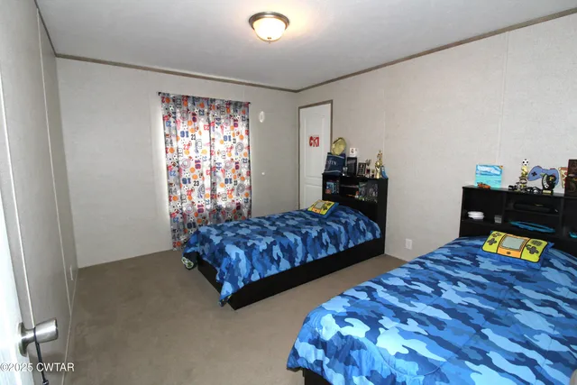 a bedroom with bed and a window