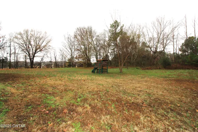 a view of outdoor space with deck and yard