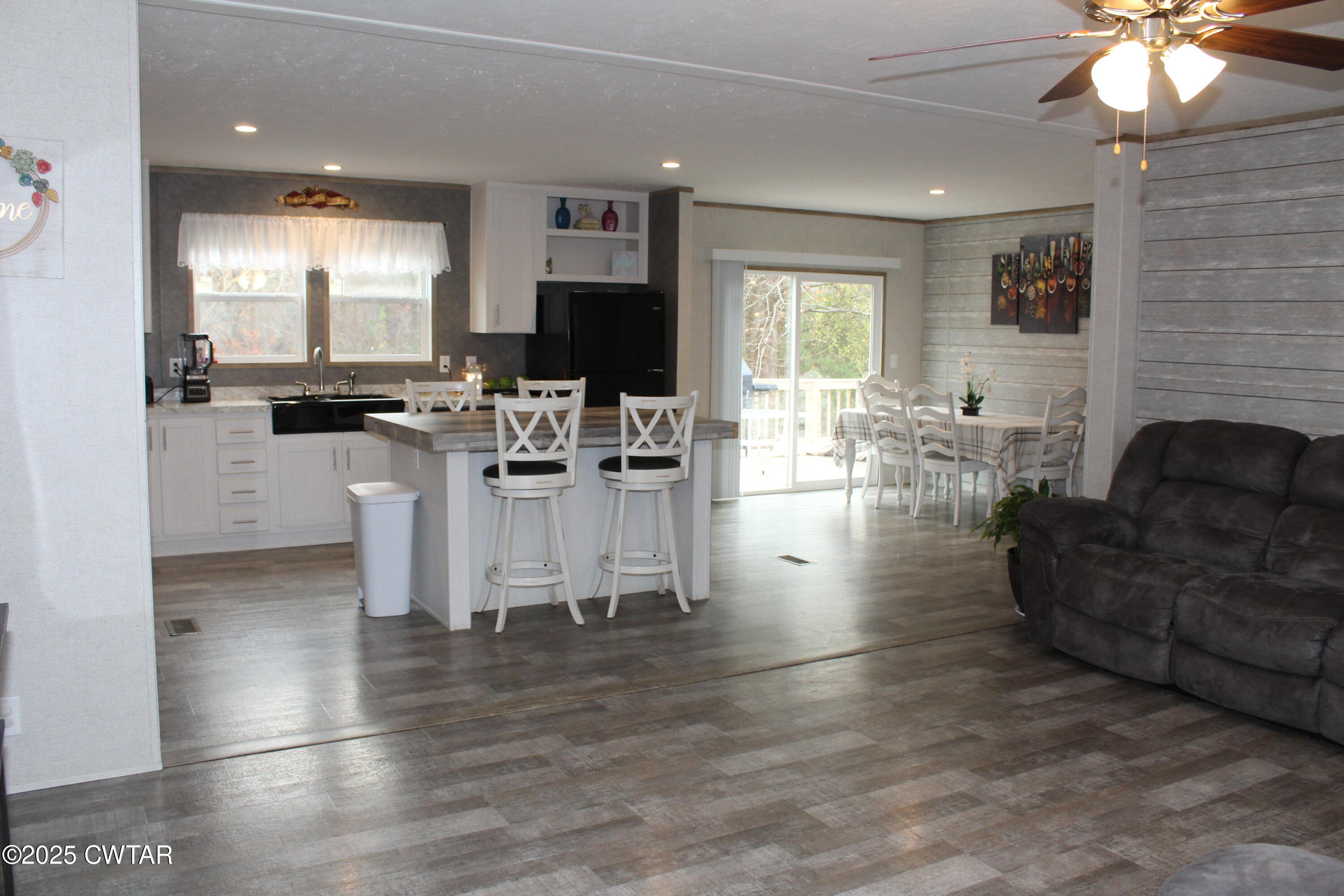 34 Rubin White Road Bradford, TN 38316 - Photo 5 of 35 a living room with furniture a fireplace and a flat screen tv