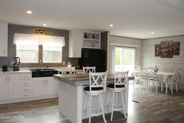 a large kitchen with a large counter top furniture and stainless steel appliances