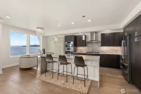 a large kitchen with a table and chairs