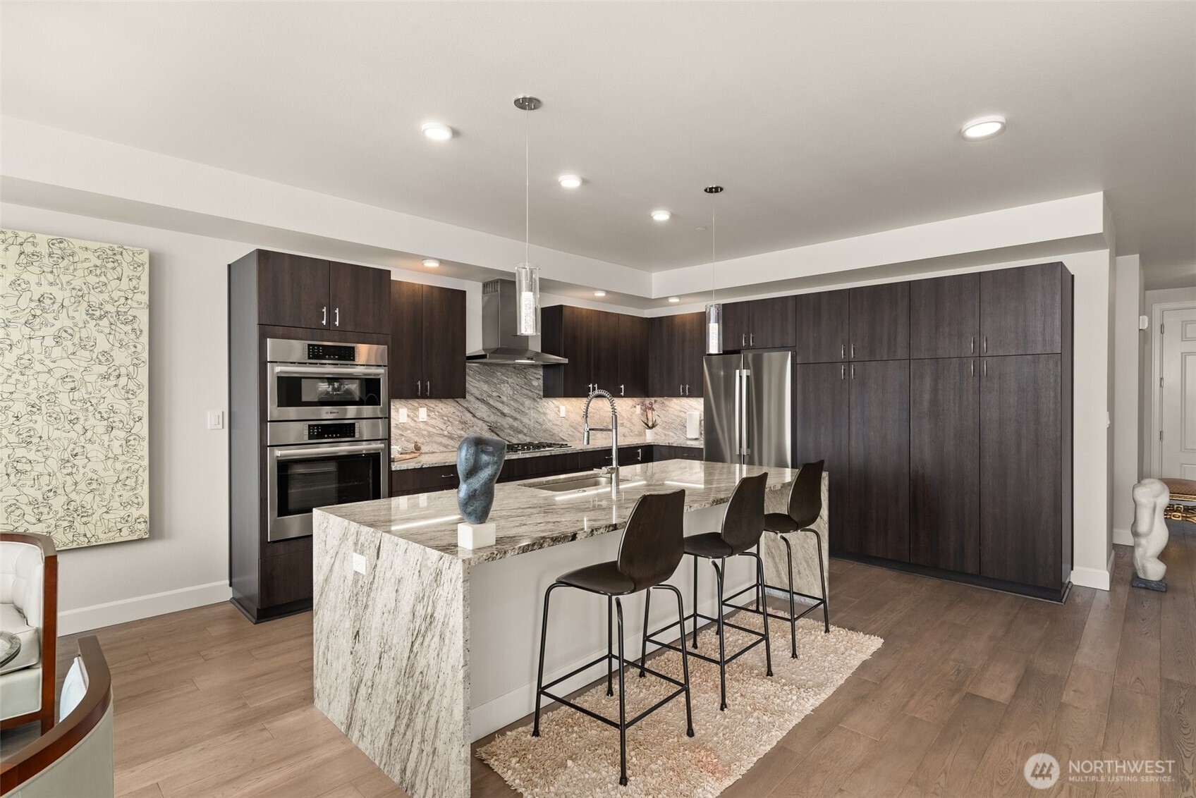 4961 Main Street, Unit 802 Tacoma, WA 98407 - Photo 13 of 39 a view of a dining room with furniture and chandelier