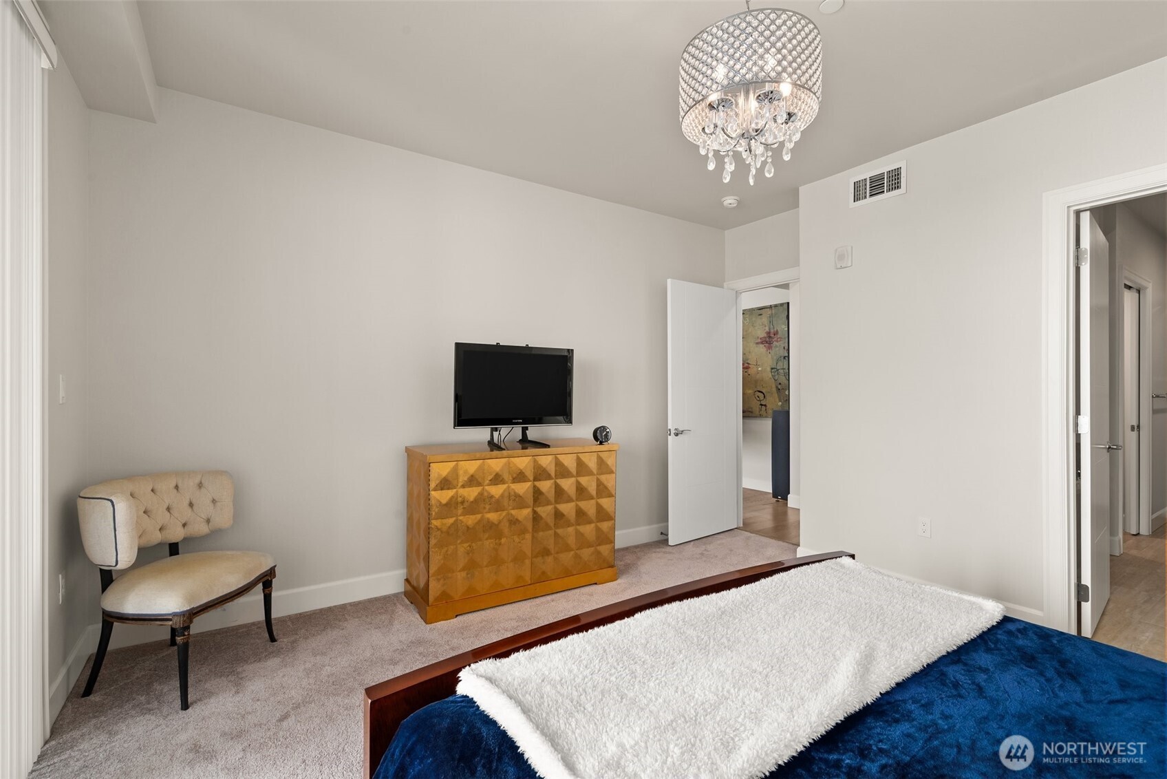 4961 Main Street, Unit 802 Tacoma, WA 98407 - Photo 18 of 39 a bedroom with furniture and a flat screen tv