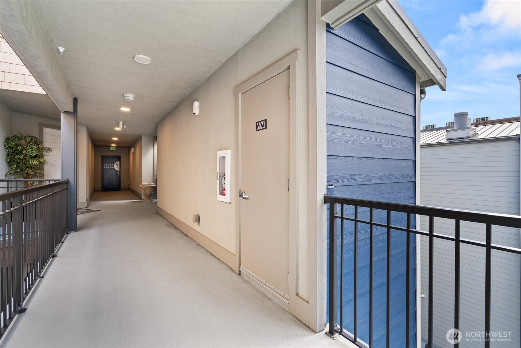 4961 Main Street, Unit 802 Tacoma, WA 98407 - Photo 28 of 39 a view of a hallway with wooden floor
