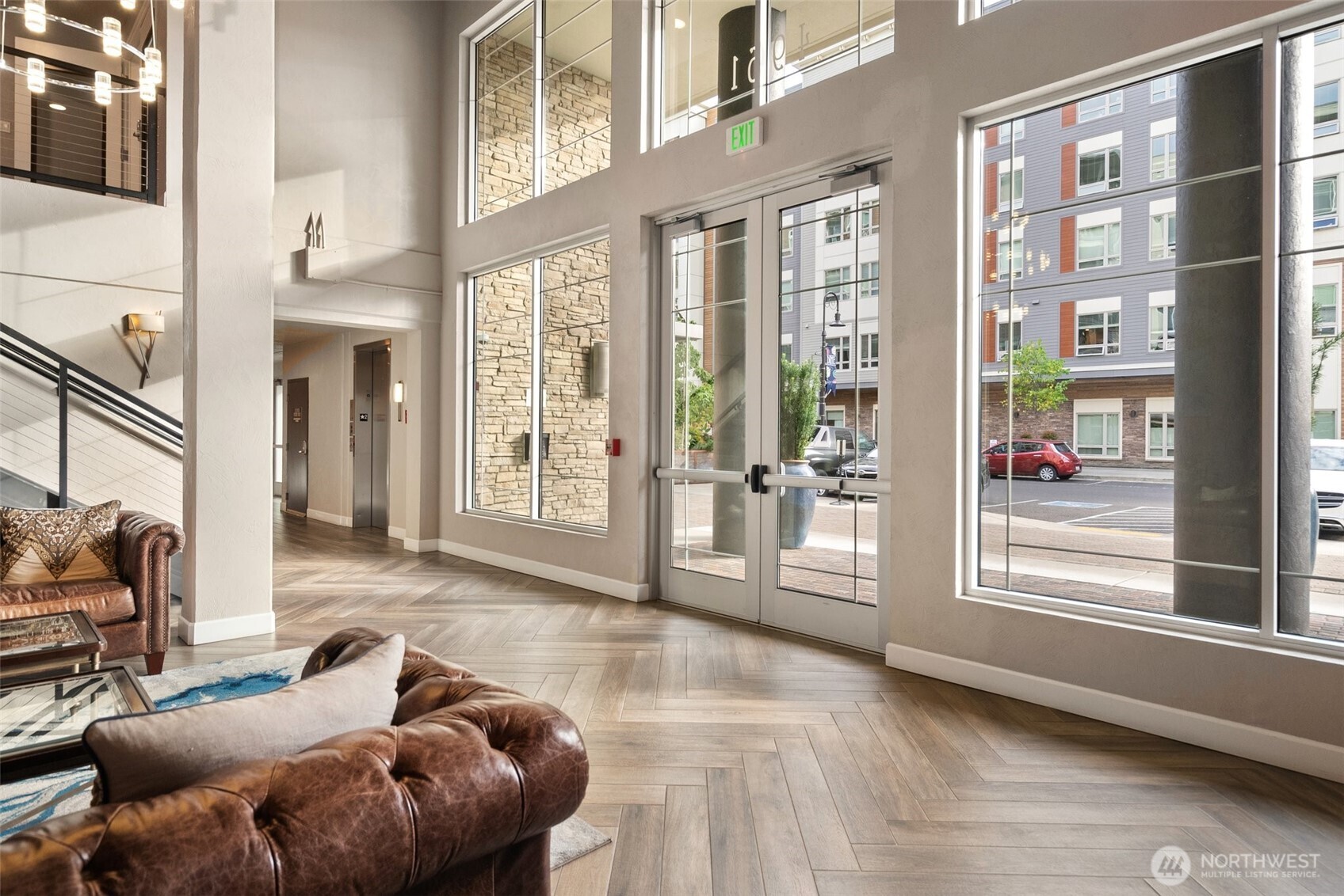 4961 Main Street, Unit 802 Tacoma, WA 98407 - Photo 30 of 39 a living room with furniture and a floor to ceiling window