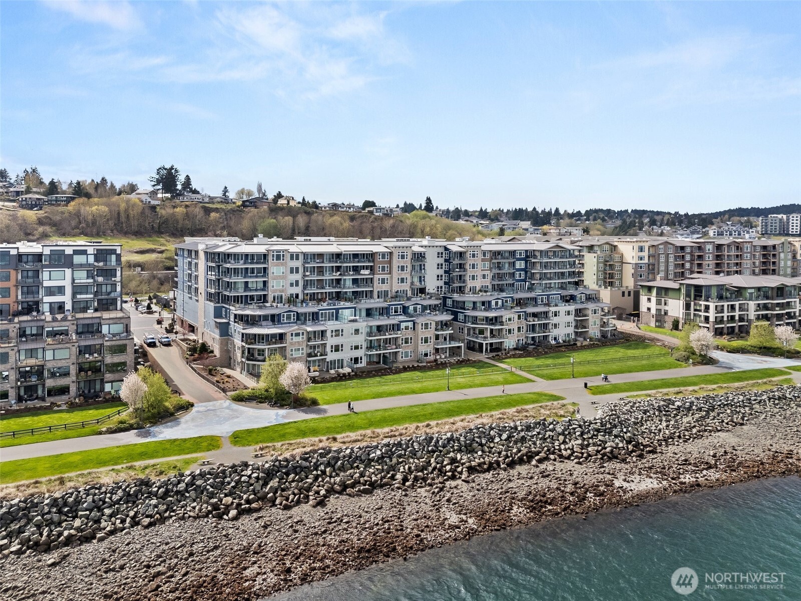 4961 Main Street, Unit 802 Tacoma, WA 98407 - Photo 36 of 39 a view of a swimming pool with a lawn chairs and a big yard