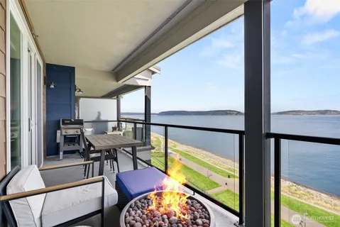 a balcony view with a large window and sitting space