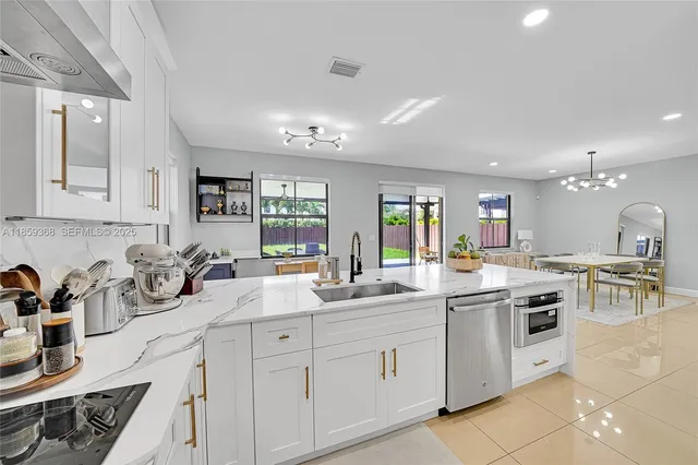 a kitchen with sink a stove and cabinets