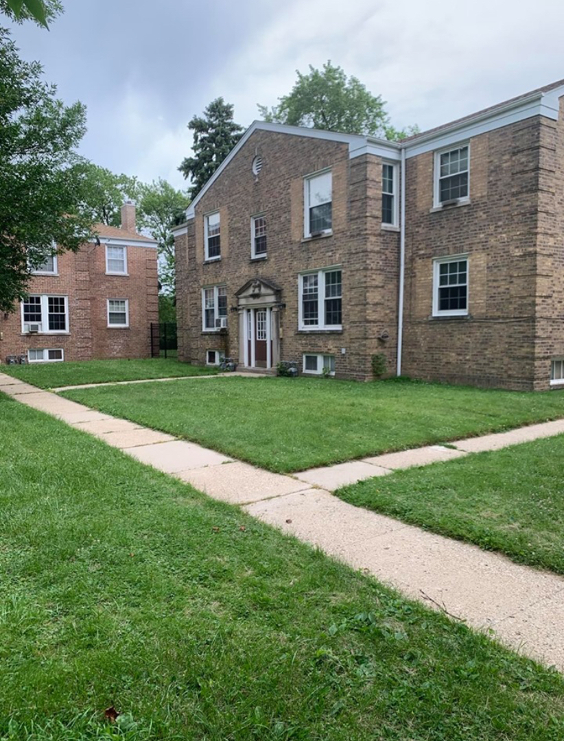4264 West Nelson Street, Unit 2 Chicago, IL 60641 - Photo 1 of 7 a front view of house with yard and green space
