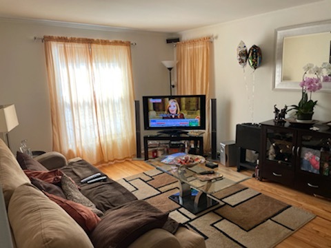 4264 West Nelson Street, Unit 2 Chicago, IL 60641 - Photo 3 of 7 a living room with furniture and a flat screen tv