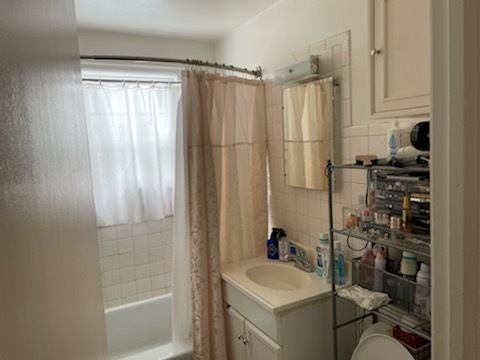 4264 West Nelson Street, Unit 2 Chicago, IL 60641 - Photo 4 of 7 a bathroom with a sink a toilet and shower