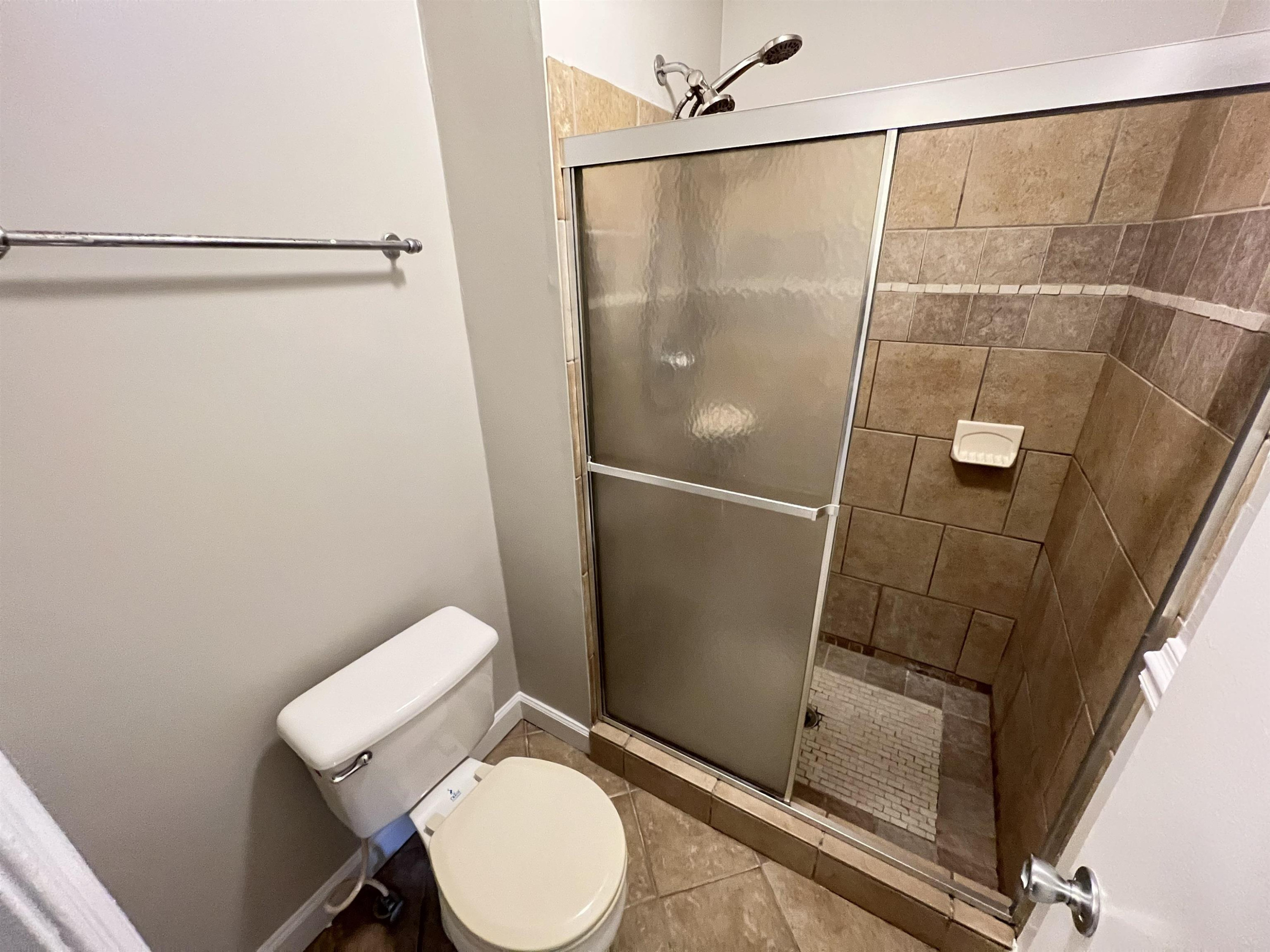 1227 Seaton Road, Unit 33 Durham, NC 27713 - Photo 11 of 21 a white toilet sitting next to a shower