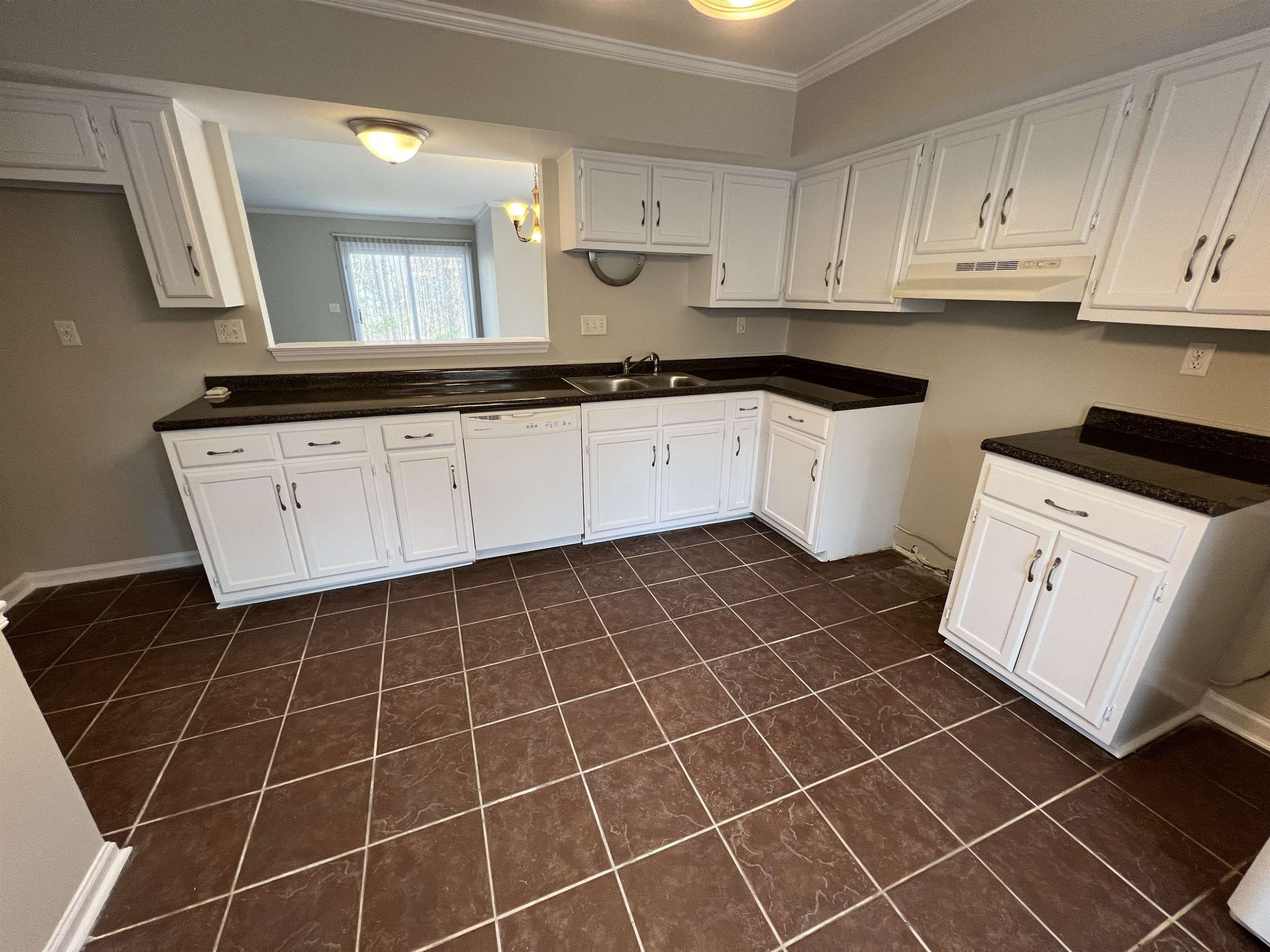 1227 Seaton Road, Unit 33 Durham, NC 27713 - Photo 20 of 21 a kitchen with a sink a stove and cabinets