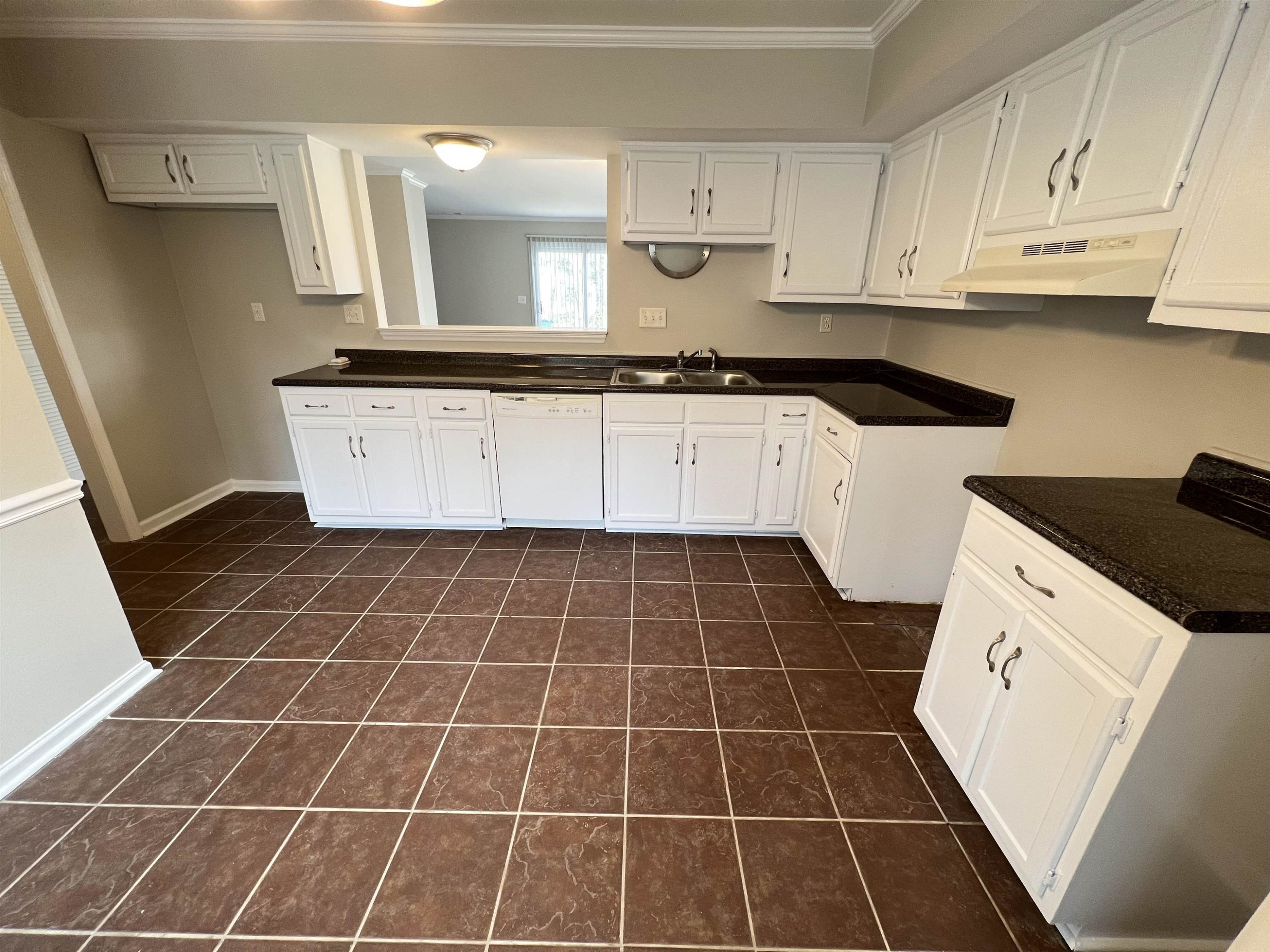 1227 Seaton Road, Unit 33 Durham, NC 27713 - Photo 3 of 21 a view of a kitchen with granite countertop white cabinets and black appliances