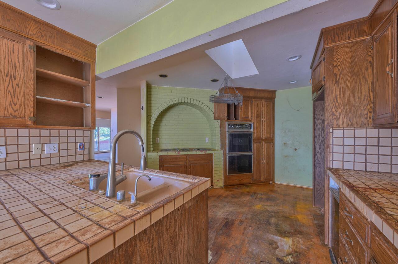 26045 Toro Road Salinas, CA 93908 - Photo 12 of 35 a kitchen with a sink and a stove top oven
