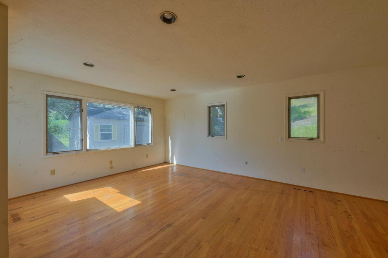 26045 Toro Road Salinas, CA 93908 - Photo 16 of 35 an empty room with wooden floor and windows