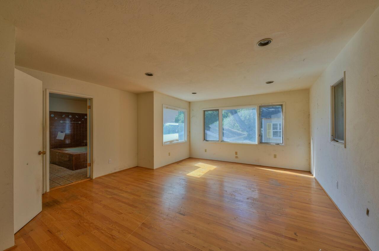 26045 Toro Road Salinas, CA 93908 - Photo 17 of 35 a view of an empty room with a window and wooden floor
