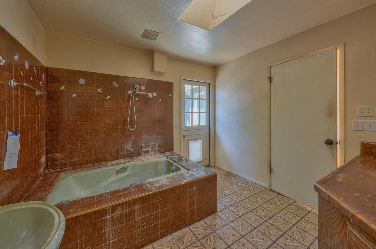 26045 Toro Road Salinas, CA 93908 - Photo 19 of 35 a bathroom with a granite countertop sink a toilet and shower